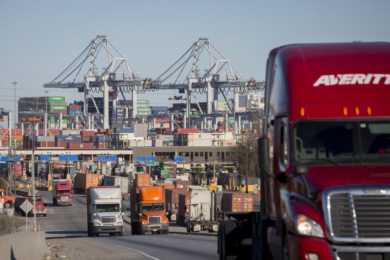 FILE- In this Jan. 30, 2018, file photo, tractor-trailers move cargo out of the Port of Savannah in Savannah, Ga.  (AP Photo/Stephen B. Morton, File)