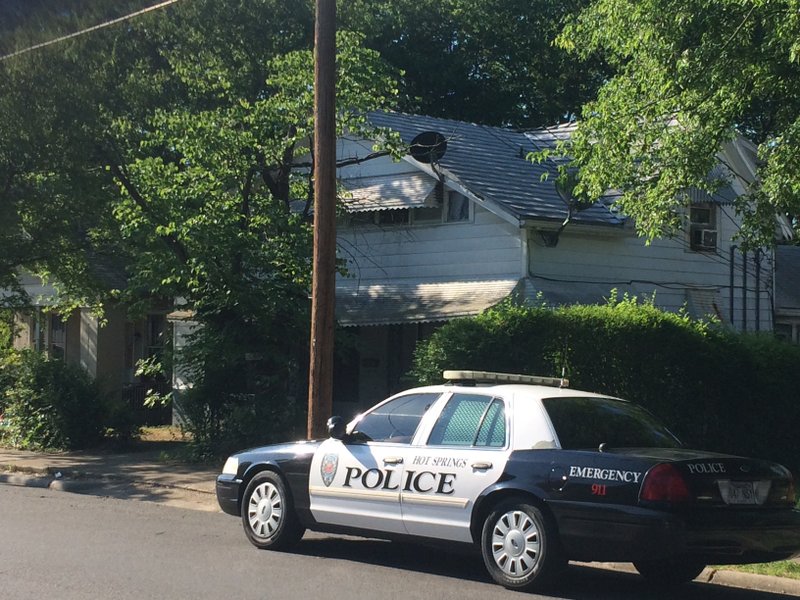 A police car waits outside a home in the 400 block of Alcorn Street in Hot Springs where a possible explosive device was discovered earlier Thursday morning.