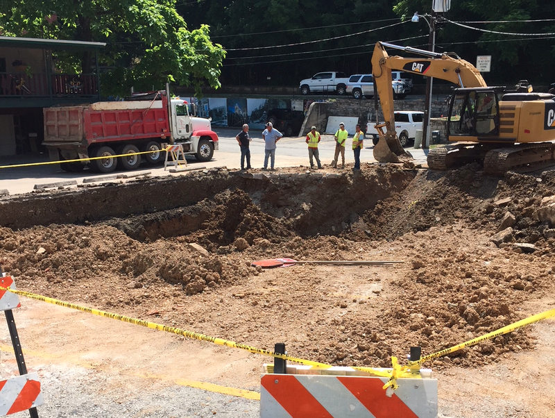 A tunnel collapsed underneath a parking lot on Main Street in Eureka Springs, creating a large hole.