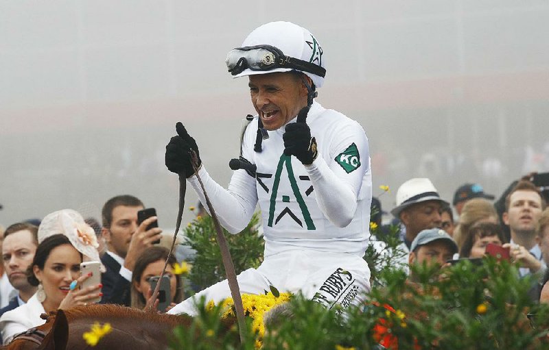 Jockey Mike Smith celebrates after winning the Preakness Stakes aboard Justify on May 19. The duo will attempt to be the 13th Triple Crown winner Saturday in the Belmont Stakes. 