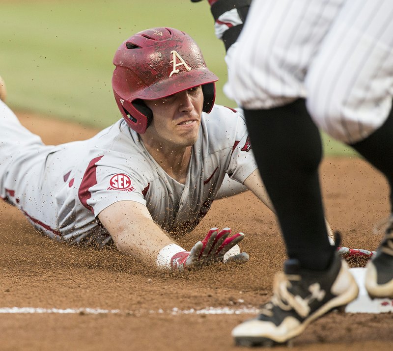 NWA Democrat-Gazette/Ben Goff NOT DONE YET: Arkansas redshirt senior second baseman Carson Shaddy slides in safe at third base on a hit in the second inning against Southern Mississippi Saturday during the Fayetteville Regional at Baum Stadium. Shaddy was picked in the 10th round of the Major League Baseball Draft Tuesday by the Washington Nationals.