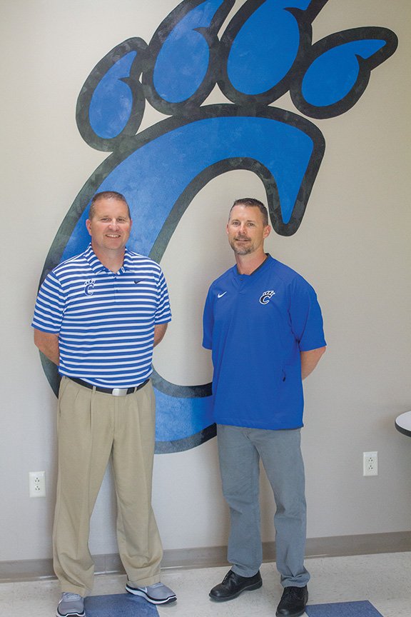 New Conway High School football coach Keith Fimple, left, stands with new Conway School District athletic director Clint Ashcraft. Fimple is replacing Ashcraft as head football coach following Ashcraft’s promotion to athletic director. 