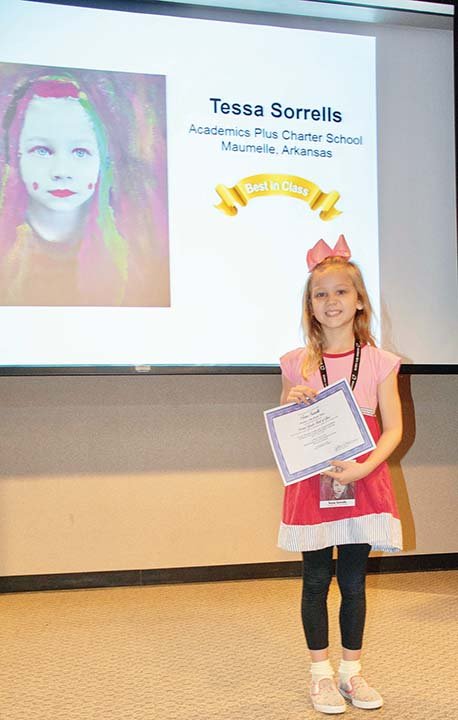 Tessa Sorrells, a second-grader at Academics Plus Charter School in Maumelle, shows her Best in Class award in the Young Arkansas Artists exhibition. She received the award with a mixed-media 
self-portrait painting.
