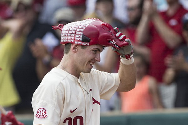 Hunter Wilson (6) of Arkansas gives Carson Shaddy (20) the home run hog hat after Shaddy hit a home run in the 6th inning against Oral Roberts Friday, June 1, 2018, during game one of the NCAA regional at Baum Stadium. Arkansas won 10-2.