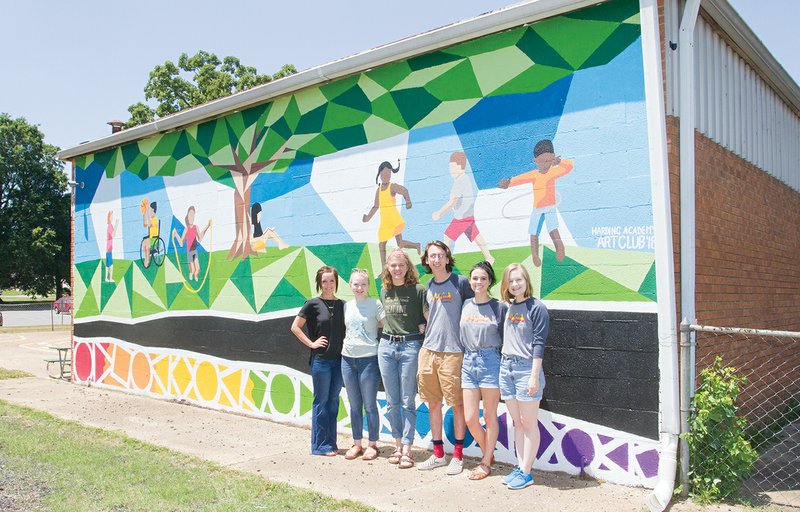 Standing in front of the new mural at the Searcy Head Start Center are Director Alicia Cherry, from left, and Harding Academy Art Club students Carissa Smith and Emma Steil, seniors, and Mason LaFerney and Kathryn Wilkins, both of whom graduated this year; and Maggie Lake, art teacher at Harding Academy. LaFerney submitted the winning design that Art Club members painted. The Head Start staff is now looking for volunteers to donate paint sprayers and their time to paint the rest of the building at 610 Moss St.