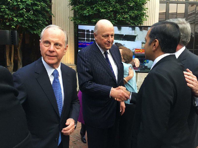 Mack McLarty (left) and John D. Negroponte, former U.S. ambassador to the United Nations and vice chairman of McLarty Associates, greet guests Wednesday at their event near the Smithsonian Castle in Washington. 