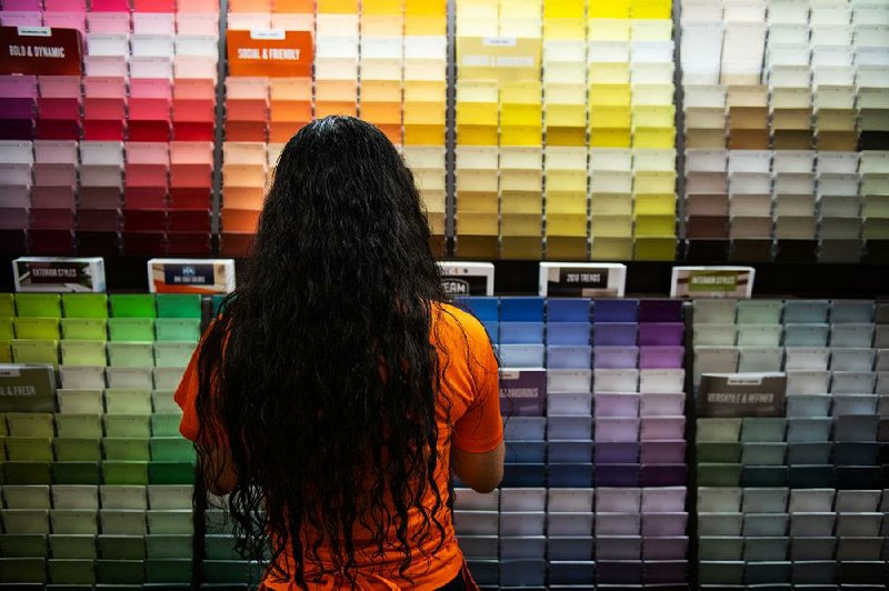 An employee checks on stocks of color samples at a Home Depot Inc. store in New York last month.  