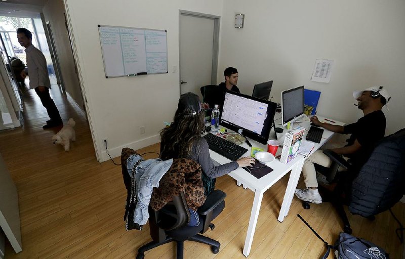 In this photo taken in late May, people work in the offices of Hey-Tutor, an online company that matches tutors with students in Los Angeles.  