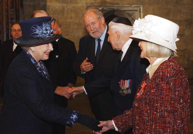 FILE - In this Thursday, Jan. 27, 2005 file photo, Britain's Queen Elizabeth II, left, meets Holocaust survivor Gena Turgel during a service to remember victims of the Holocaust in Westminster Central Hall in London on the 60th anniversary of the liberation of Auschwitz. Turgel, a Holocaust survivor who comforted diarist Anne Frank at the Bergen-Belsen concentration camp months before its liberation, has died. She was 95. Britain's chief rabbi, Ephraim Mirvis, said Turgel died Thursday, June 7, 2018. (Kirsty Wigglesworth, Pool Photo via AP, File)