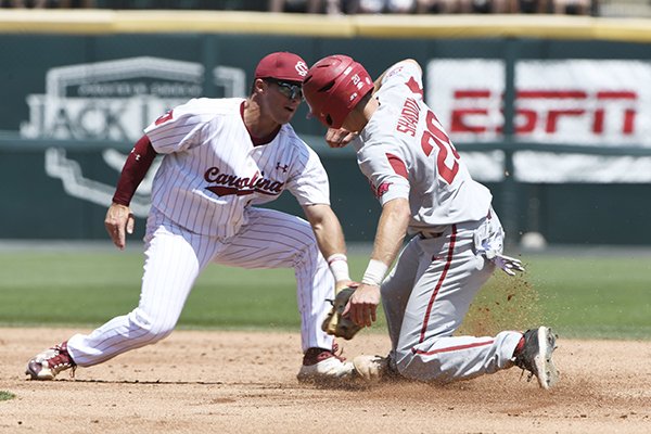 South Carolina's second baseman Justin Row tries to put the tag on Arkansas baserunner Carson Shaddy as he steals second base in the second inning of an NCAA college baseball tournament super regional baseball game in Fayetteville, Ark., Sunday, June 10, 2018. (AP Photo/Michael Woods)


