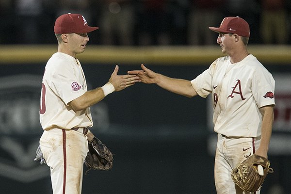 Arkansas infielders Carson Shaddy, left, and Jax Biggers celebrate following an NCAA Tournament win over South Carolina on Saturday, June 9, 2018, in Fayetteville. 
