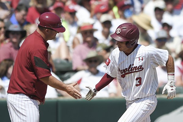 South Carolina infielder Justin Row (3) scores during the second game of the NCAA super regional baseball, Sunday, June 10, 2018 at Baum Stadium in Fayetteville. Arkansas fell to South Carolina 8-5.
