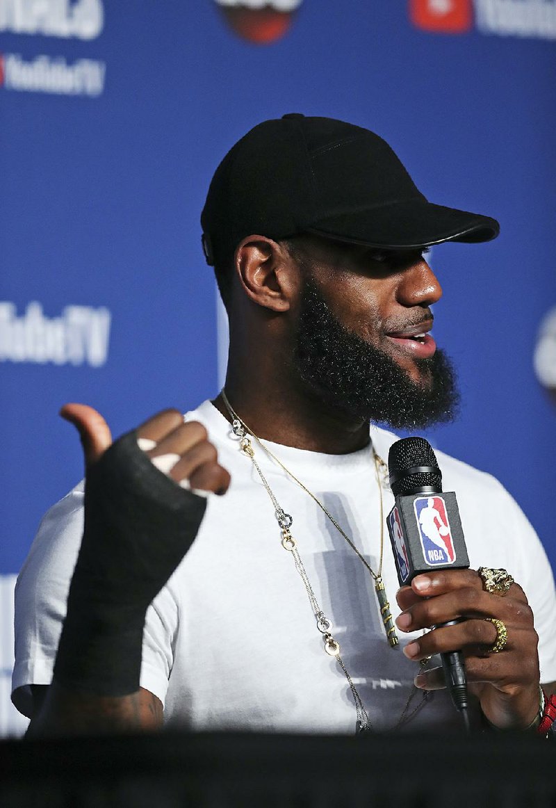 Cleveland Cavaliers forward LeBron James confirmed news of a hand injury by wearing a cast during a news conference following Friday’s Game 4 of the NBA Finals against the Golden State Warriors.  