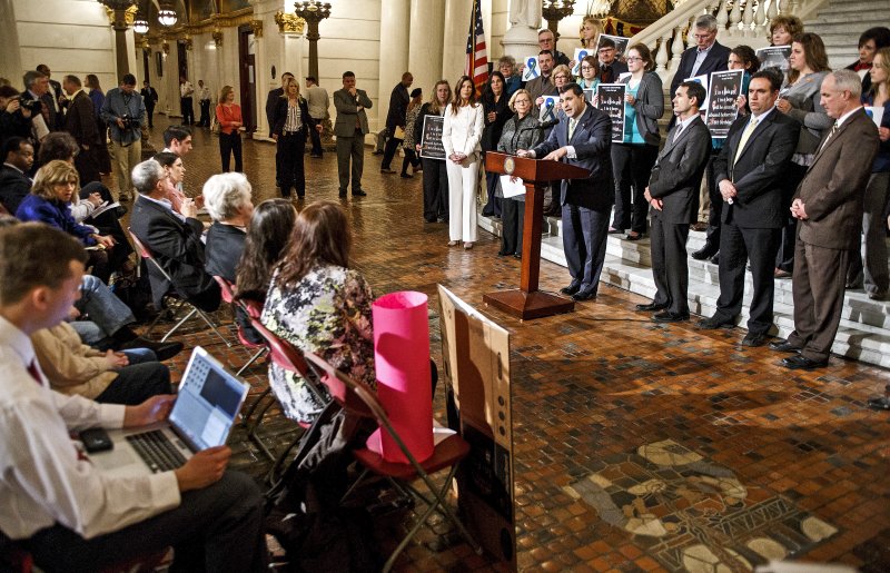 In this March 14, 2016, file photo, Pennsylvania state Rep. Mark Rozzi, D-Berks, speaks during a child sex abuse statute of limitations rally attended by advocates, legislators, victims and state Attorney General Kathleen Kane, in white, in the rotunda of the state Capitol in Harrisburg, Pa. Rozzi later testified about his own experience of abuse by a priest in the Allentown diocese as part of a Pennsylvania grand jury's probe into the handling of sexual abuse claims by Roman Catholic dioceses in Allentown, Erie, Greensburg, Harrisburg, Pittsburgh and Scranton, and the grand jury's findings could be made public nearly two years after the investigation began in July 2016. (Dan Gleiter/PennLive.com via AP, File)