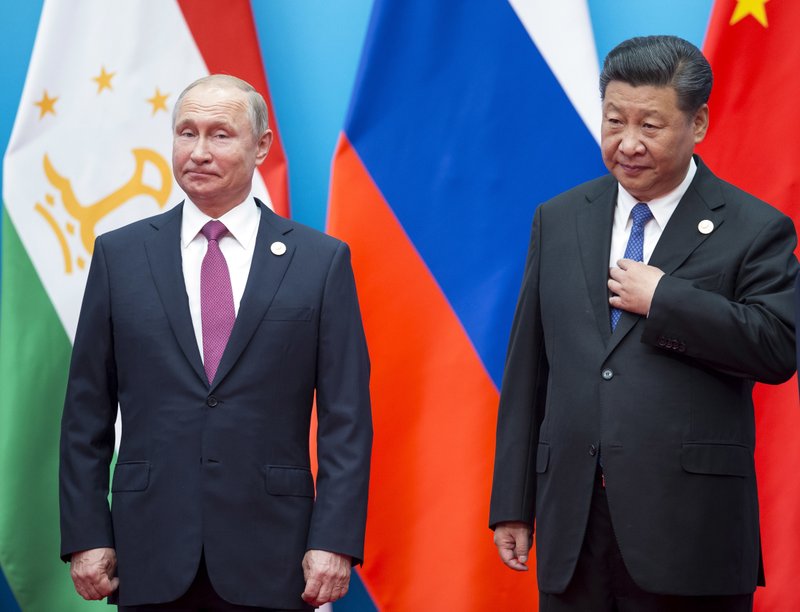 Chinese President Xi Jinping, right, and Russian President Vladimir Putin pose for a photo at the Shanghai Cooperation Organization (SCO) Summit in Qingdao in eastern China's Shandong Province Sunday, June 10, 2018. (AP Photo/Alexander Zemlianichenko)