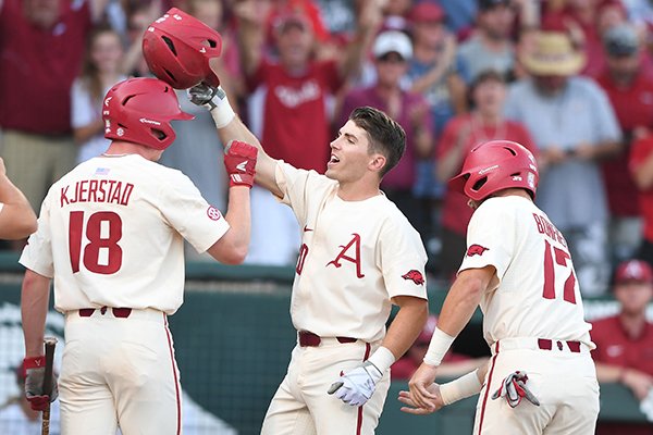 Arkansas second baseman Carson Shaddy (20) celebrates after hitting a home run during the first inning of an NCAA Tournament game against South Carolina on Monday, June 11, 2018, in Fayetteville. 