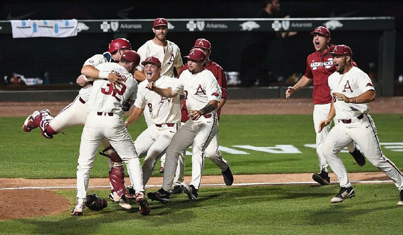 The Razorbacks celebrate after defeating South Carolina 14-4 on Monday in the Fayetteville Super Regional championship game at Baum Stadium. Arkansas qualified for its ninth College World Series and fifth under Coach Dave Van Horn. 