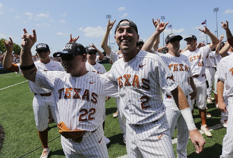 Texas infielder Kody Clemens (2) celebrates with head coach David Pierce (22) and teammates following their win over Tennessee Tech in an NCAA college super regional baseball game, Monday, June 11, 2018, in Austin, Texas. Texas won 5-2. 