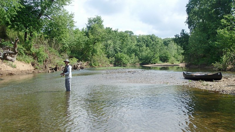 NWA Democrat-Gazette/FLIP PUTTHOFF Bruce Darr fishes on the War Eagle River in May during a float from Withrow Springs State Park to a take-out where Madison County 8500 dead ends at the stream.