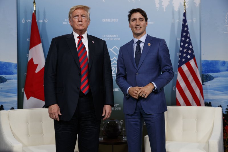 U.S. President Donald Trump meets with Canadian Prime Minister Justin Trudeau at the G-7 summit, Friday, June 8, 2018, in Charlevoix, Canada. (AP Photo/Evan Vucci)