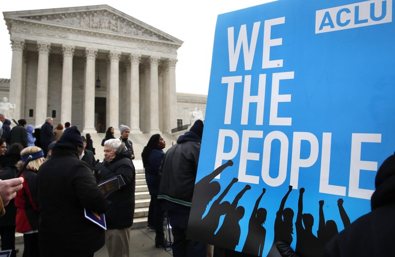 FILE - In this Jan. 10, 2018, file photo, people rally outside of the Supreme Court in opposition to Ohio's voter roll purges in Washington. The Supreme Court is allowing Ohio to clean up its voting rolls by targeting people who haven't cast ballots in a while. (AP Photo/Jacquelyn Martin, File)