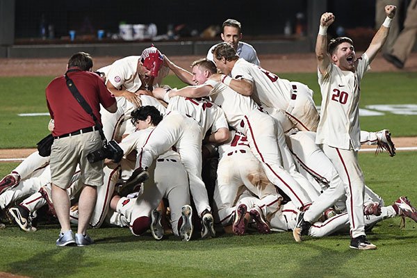 Arkansas players dog pile after defeating South Carolina 14-4 on Monday, June 11, 2018, in Fayetteville. The Razorbacks advanced to the College World Series for the ninth time in program history.