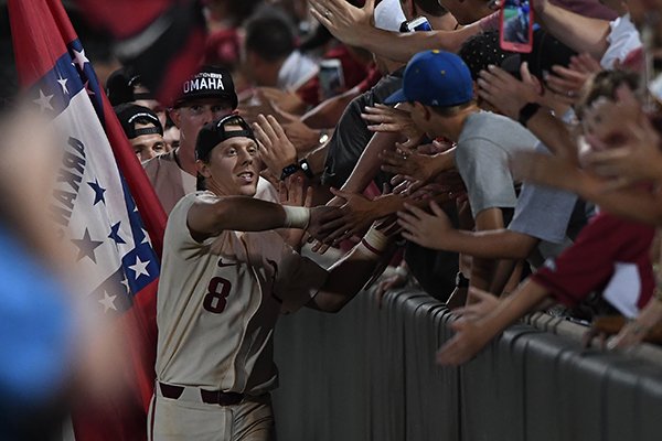 Razorbacks right fielder Eric Cole celebrates with fans following Arkansas' 14-4 win over South Carolina Monday June 11, 2018 during the NCAA Super Regional at Baum Stadium in Fayetteville.
