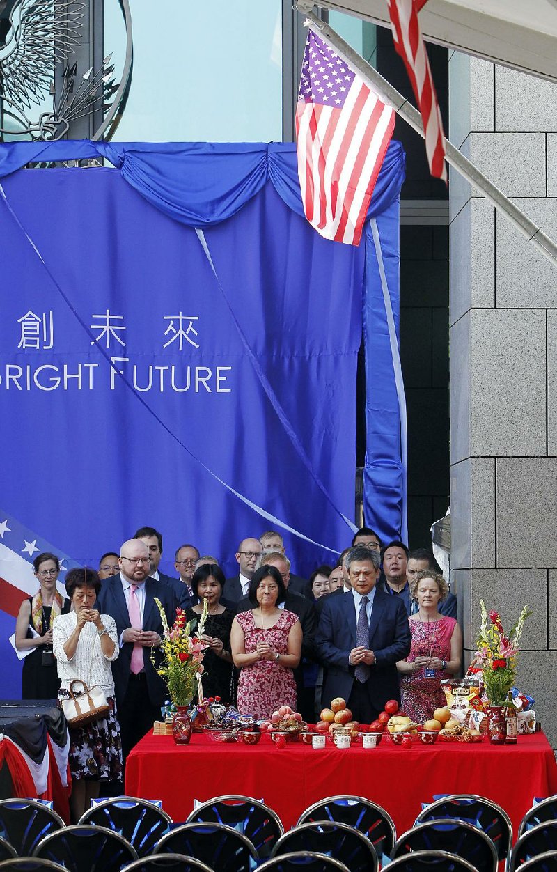 Kin Moy (second from right), the director of the American Institute in Taiwan, offers a traditional prayer at the dedication of the new American Institute in Taipei, an unofficial U.S. embassy in Taiwan.