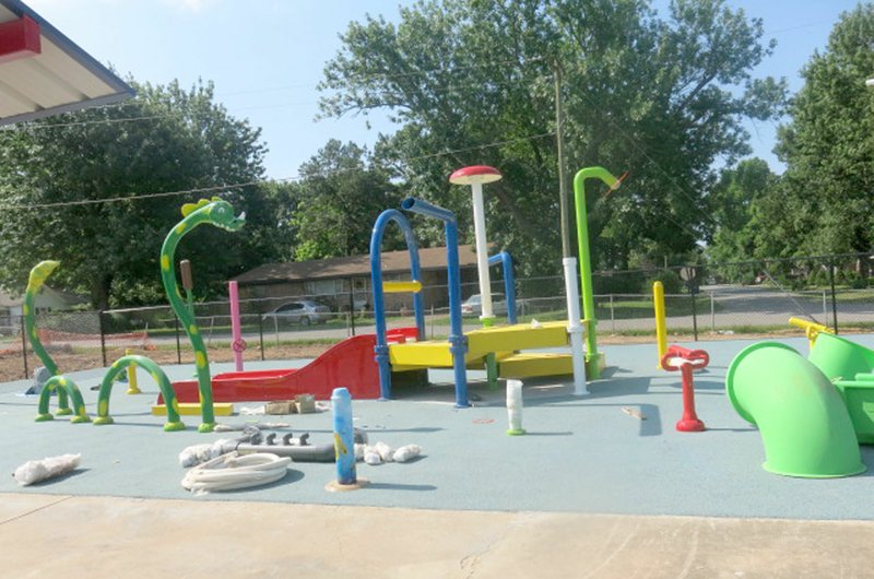 Westside Eagle Observer/SUSAN HOLLAND New playground equipment is nearing completion at the Gravette aquatic park. The water park, pavilions and waterslide await use by youngsters when the park opens at 1 p.m. Friday, June 15. Pool admission is $3, or $1.50 from 5 to 7 p.m.