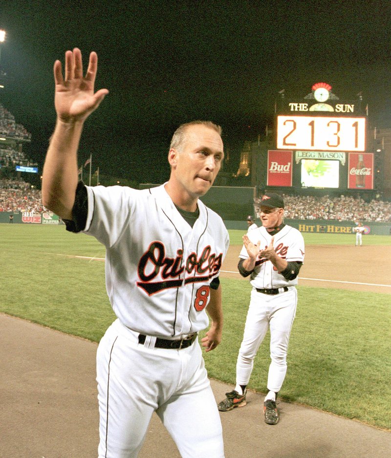 AP Photo/Denis Paquin Baltimore Orioles' Hall-of-Famer Cal Ripken Jr. waves to the crowd as the sign in centerfield reads 2,131, signifying Ripken had broken Lou Gehrig's record of playing in 2,130 consecutive games, at Camden Yards in Baltimore, in this Sept. 6, 1995, photo.