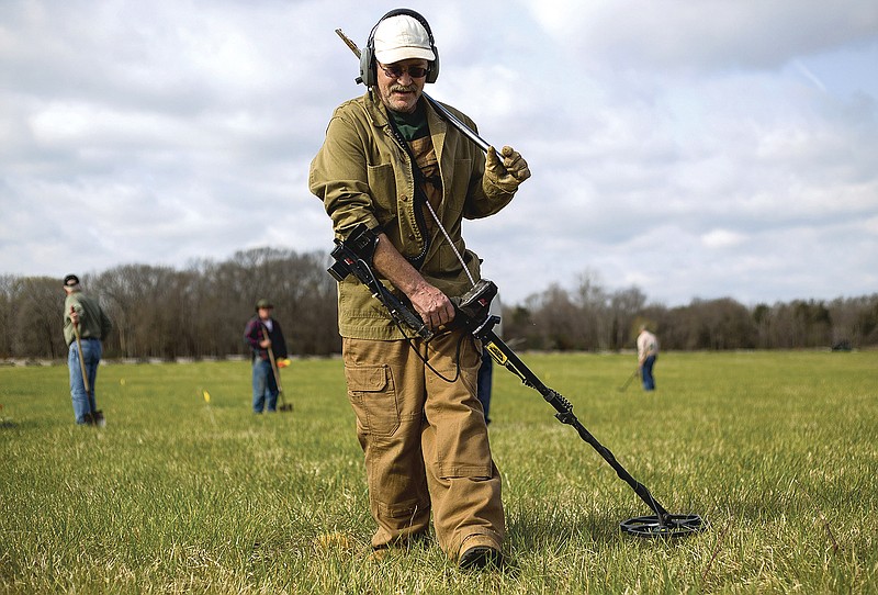 Staff photograph by Jason Ivester Doug Dorothy of Lowell scanned a quadrant with his metal detector in Ruddick's Field at the Pea Ridge National Military Park. "That's Civil War right there," he called as he unearthed his first piece of canister shot for the day. Archaeologists from the Arkansas Archeological Survey, park staff and volunteers surveyed 27 acres of the field, searching for remnants of the Civil War battle fought here in 1862.