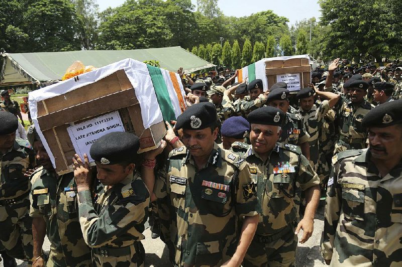 Indian Border Security Force officers in Jammu, India carry the coffins of four of their colleagues who were killed early Wednesday near the border with Pakistan.  
