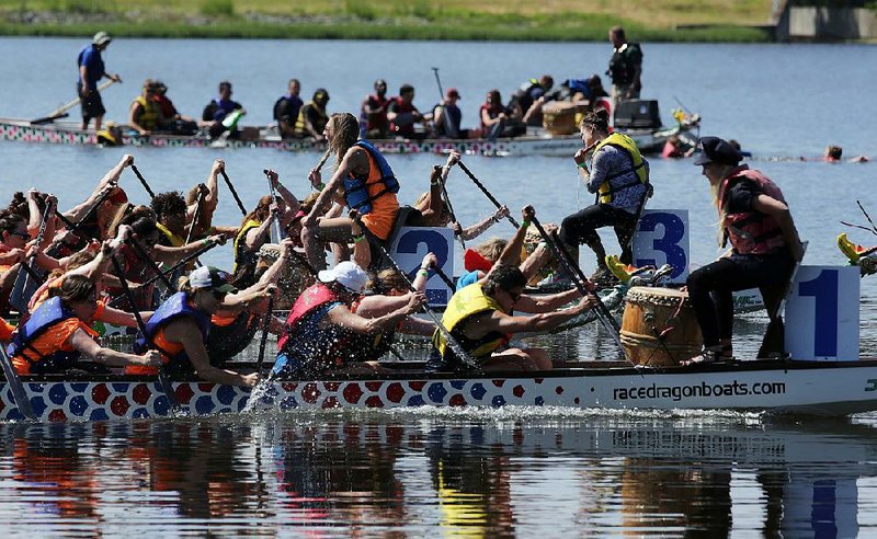 Teams paddle furiously to the beat of the drums in the River Cities Dragon Boat Festival on Lake Willastein in Maumelle. The race-filled festival benefits the Children’s Protection Center and its work with survivors of child abuse.  
