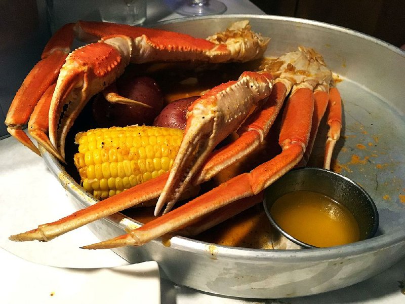 A pound of snow crab legs, with melted butter, a corn cobette and two baseball-size potatoes, nearly fill the metal serving tray at The Juicy Seafood.  