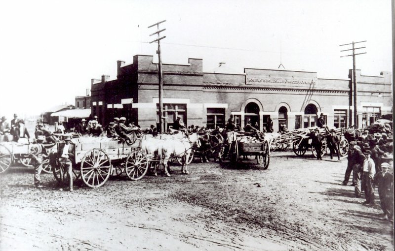 Photo courtesy of the Rogers Historical Museum Local residents brought wood on Saturday to sell in front of the Rogers Wholesale Grocery about 1910. (Note there is not a single female in the picture.) Before the days of the big chain groceries, there was a mom-and-pop grocery on every corner. Rogers Wholesale supplied merchandise to these stores.