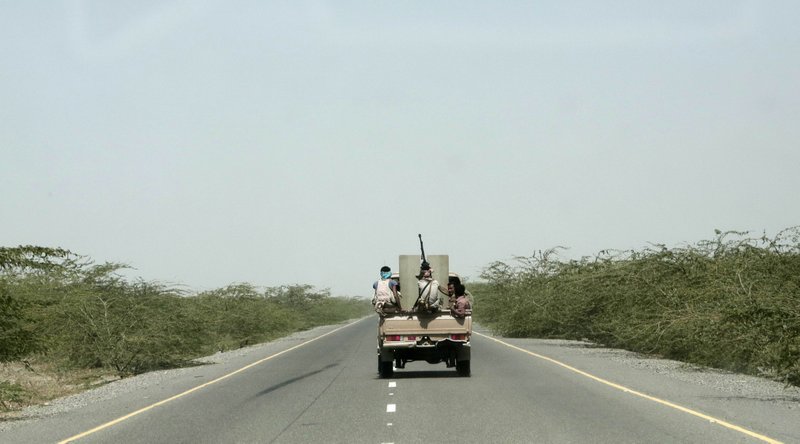 FILE - In this Feb. 12, 2018 file photo, Saudi-backed forces, part of Ahmed al-Kawkabani's, southern resistance unit in Hodeida, ride in their vehicle, in Hodeida, Yemen. The Saudi-led coalition backing Yemen's exiled government began an assault Wednesday, June 13, 2018 on the port city of Hodeida, the main entry point for food in a country already teetering on the brink of famine.(AP Photo/Nariman El-Mofty, File)