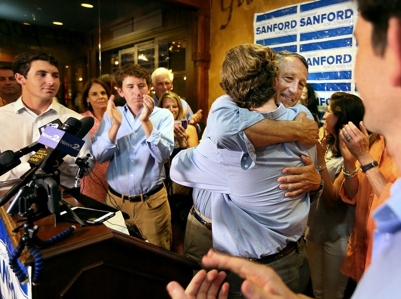 U.S. Rep. Mark Sanford hugged his sons after addressing his supporters at Liberty Tap Room in Mount Pleasant, S.C., Tuesday, June 12, 2018. Sanford lost his first election ever Tuesday, beaten for the Republican nomination for another term in the coastal 1st District around Charleston by state Rep. Katie Arrington. (Wade Spees/The Post And Courier via AP)