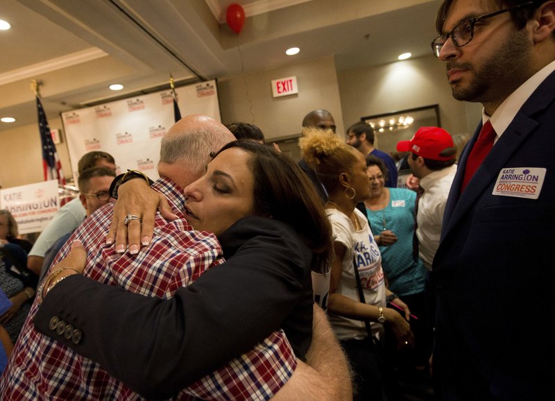 State Rep. Katie Arrington hugs supporters as she defeated U.S. Rep. Mark Sanford at the DoubleTree by Hilton Hotel for Katie Arrington's results party on Tuesday, June 12, 2018, in North Charleston, S.C. (Andrew Whitaker/The Post And Courier via AP)