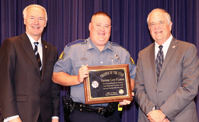 From left, Arkansas Gov. Asa Hutchinson, Trooper Levi Fleming and Col. Bill Bryant, director of Arkansas State Police