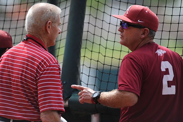 Former Arkansas baseball coach Norm DeBriyn (left) speaks with coach Dave Van Horn Thursday, June 1, 2017, during practice at Baum Stadium in Fayetteville. Teams spent the day practicing ahead of today's opening round of games in the NCAA Fayetteville Regional baseball tournament. 