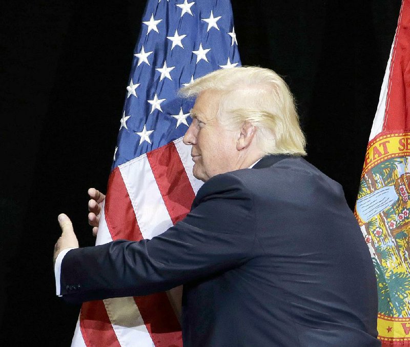 President Donald Trump celebrates his 72nd birthday Thursday by hugging a flag — a daily tradition he instilled the second time he switched from being a Democrat to a Republican in 2012. Fayetteville-born Otus the Head Cat’s award-winning column of humorous fabrication appears every Saturday.
