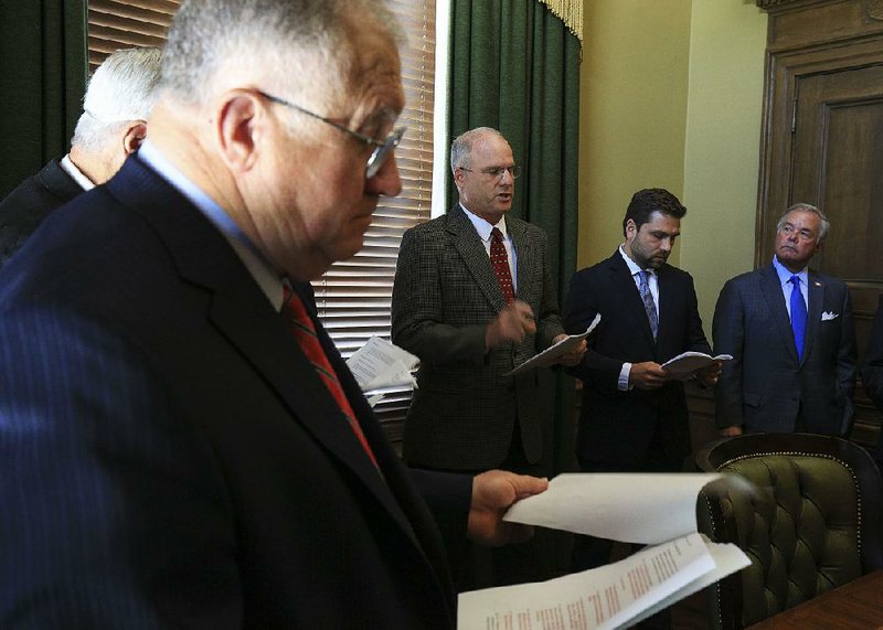 State Sen. Jim Hendren (second from left) talks about ethics rules changes Thursday as he and fellow Sens. David Wallace (left), Jonathan Dismang (second from right), Keith Ingram and others unveil the proposals at a Capitol news conference.  
