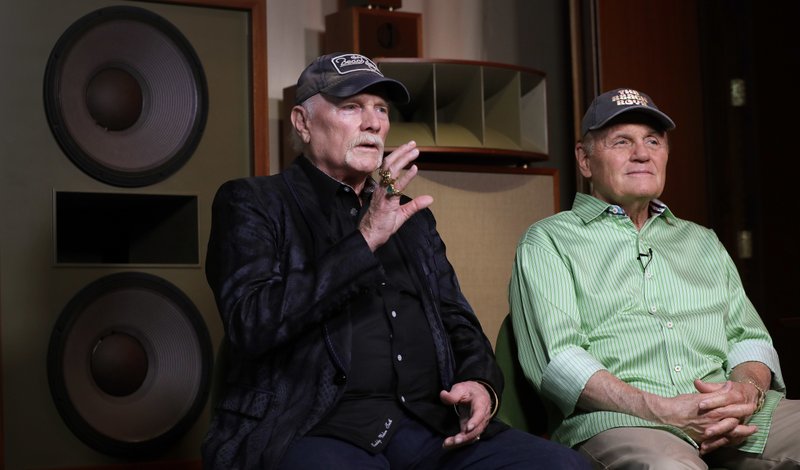 In this photo taken on Wednesday, June 13, 2018, Beach Boys musicians Mike Love, left, and Bruce Johnston, right, during an interview with Associated Press at Spiritland in London. (AP Photo/Kirsty Wigglesworth)