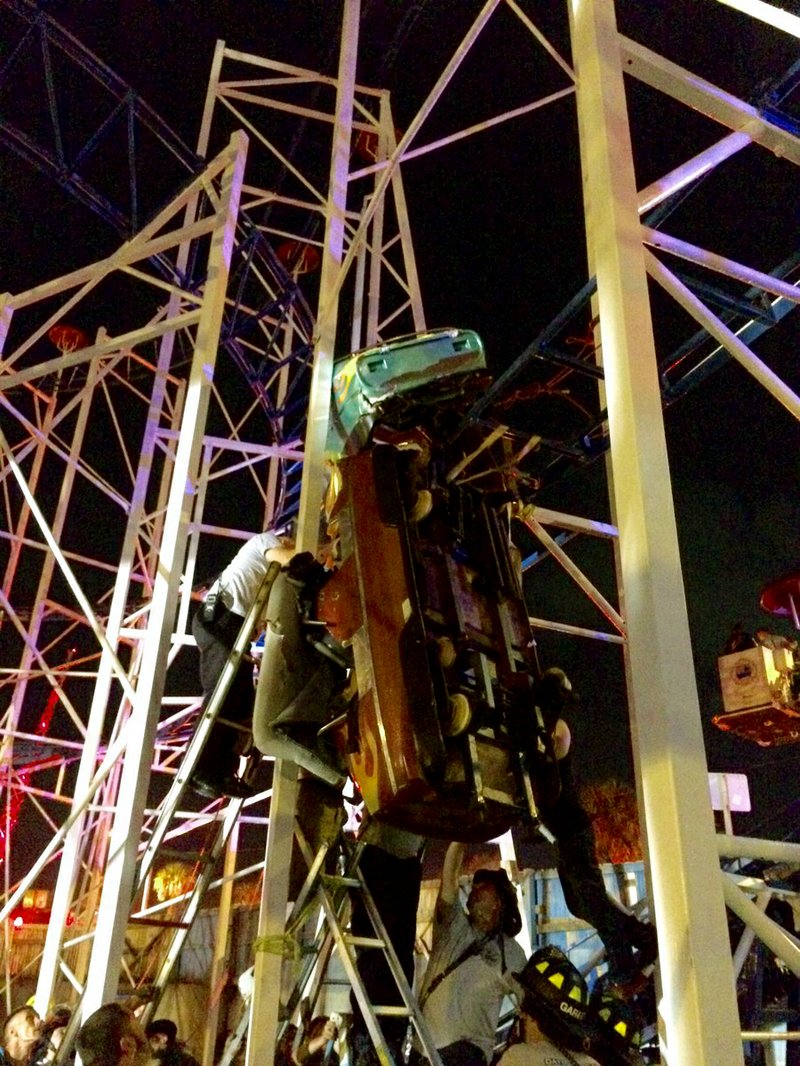 This photo provided by the Daytona Beach Fire department shows emergency crews working on a roller coaster car that derailed at the Daytona Beach Boardwalk on Thursday, June 14, 2018 in Daytona Beach, Fla. Two passengers fell 34 feet to the ground and authorities had to pull eight others to safety. The accident is under investigation according Daytona Beach Fire spokeswoman Sasha Staton. (Daytona Beach Fire department via AP)

