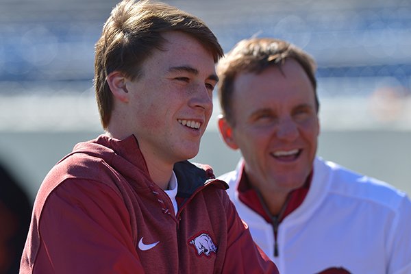 Chandler Morris (foreground) and his father, Arkansas football coach Chad Morris, watch during the Class 4A state championship game between Arkadelphia and Warren on Saturday, Dec. 9, 2017, in Little Rock. 