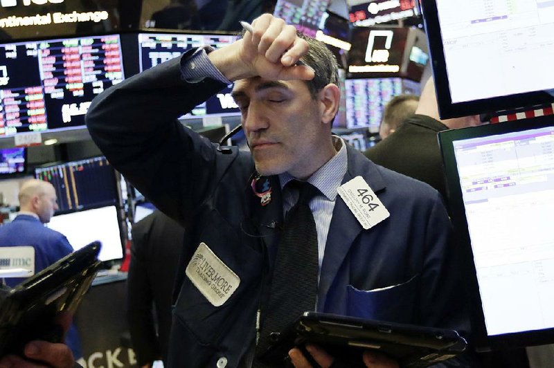 Trader Gregory Rowe works Friday on the floor of the New York Stock Exchange, where stocks fell after Friday’s announcement of U.S. tariffs on Chinese imports.   