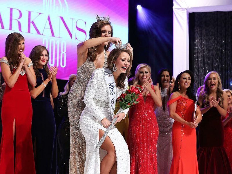 Claudia Raffo of Jonesboro is crowned Miss Arkansas 2018 by her predecessor, Maggie Benton, at the annual pageant Saturday night in Little Rock.