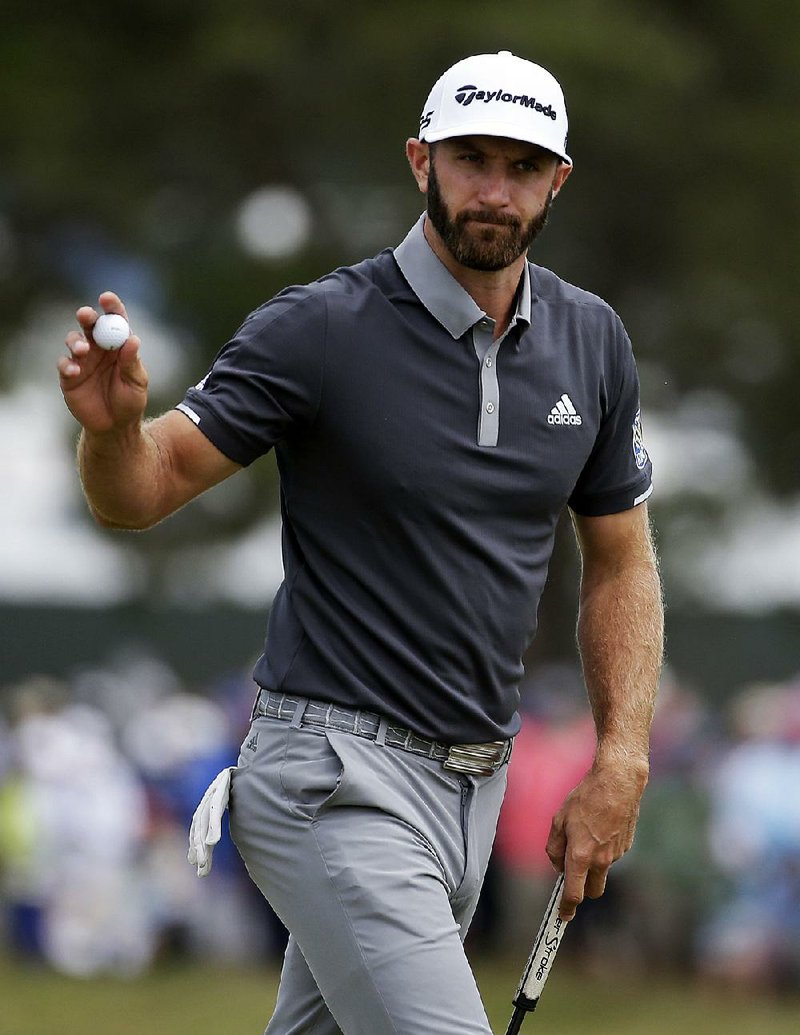 Dustin Johnson reacts after making a putt for birdie on the fourth green during the second round of the U.S. Open Golf Championship, Friday, June 15, 2018, in Southampton, N.Y.