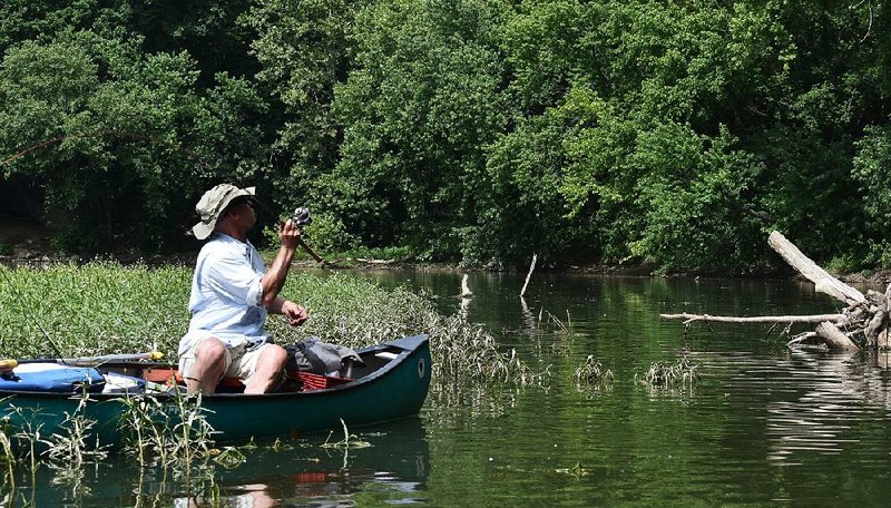 Rusty Pruitt of Bryant casts to a likely smallmouth haunt Tuesday on the Ouachita River.  