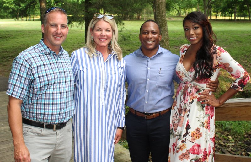 NWA Democrat-Gazette/CARIN SCHOPPMEYER Tony and Shelli Engle (from left) and Corey and Nicole Bender help support The Jones Center at the third annual Wine Walk on May 31 at Sassafras Springs Vineyard in Springdale.